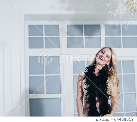 pretty blond woman in rich luxury house interior, fashion people concept 64468018