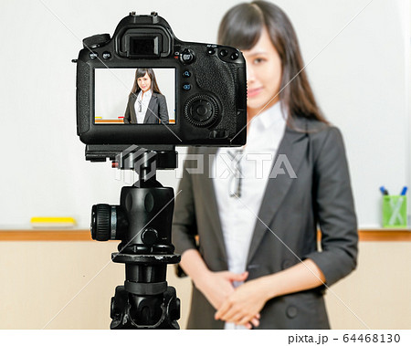 Asian American teacher streaming class with camera Asian American teacher streaming class with camera 64468130