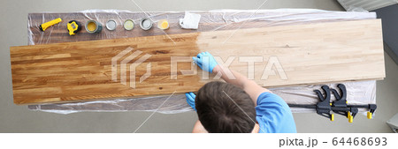 Woodworker varnishing surface Woodworker varnishing surface 64468693