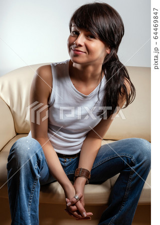 woman with long hair poses on the sofa in the apartment 64469847