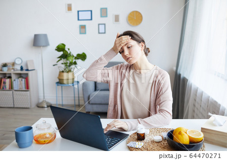 Woman has a headache Woman has a headache 64470271