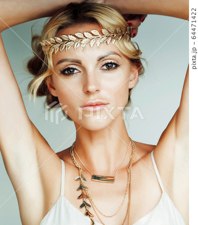 young blond woman dressed like ancient greek godess, gold jewelry and fashion makeup, people isolated on white background young blond woman dressed like ancient greek godess, gold jewelry and fashion makeup, people isolated on white background 64471422