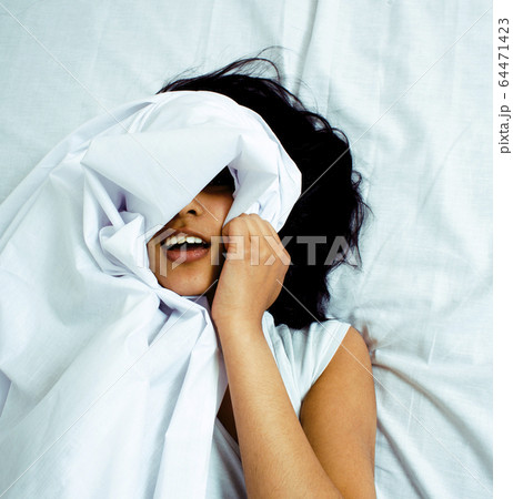 pretty brunette indian woman in bed, cant sleep, lifestyle real modern people close up pretty brunette indian woman in bed, cant sleep, lifestyle real modern people close up 64471423