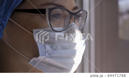 Serious Woman In Mask And Glasses Looking At Window Serious Woman In Mask And Glasses Looking At Window 64471788
