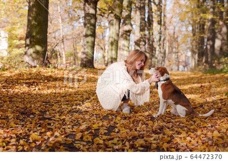 Beautiful girl with dog in the park. 64472370