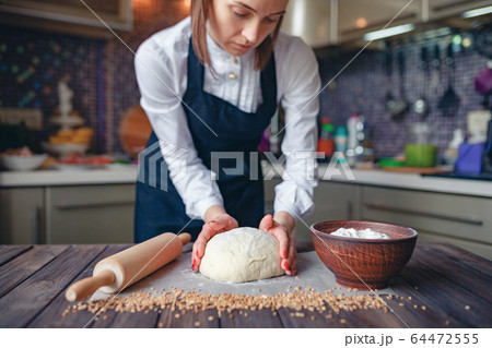 Crop woman cooking in apron Crop woman cooking in apron 64472555