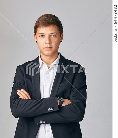 Portrait of young very serious businessman 64473482