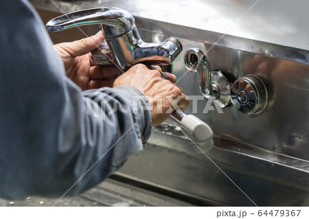 蛇口を取り付ける配管工　水道工事 64479367