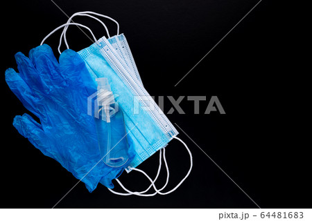 Medical mask, sanitizer and rubber glove for protection against the virus. Isolated on a black background. 64481683