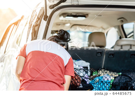 Woman cleaning with a blowers and microfiber wipe the car polishing after car wash. Woman cleaning with a blowers and microfiber wipe the car polishing after car wash. 64485675
