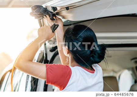 Woman cleaning with a blowers and microfiber wipe the car polishing after car wash. Woman cleaning with a blowers and microfiber wipe the car polishing after car wash. 64485676