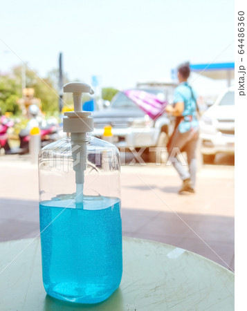 Antiseptic hand gel or alcohol gel prevent the spread of germs and bacteria and avoid infections corona virus,covid-19 prevention for serving customers in the gas station. 64486360