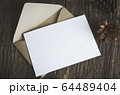 Blank white paper card with brown envelop and pine 64489404