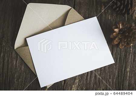 Blank white paper card with brown envelop and pine 64489404