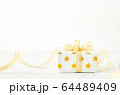 Close up of white gif box with golden star pattern 64489409
