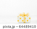 Close up of white gif box with golden star pattern 64489410
