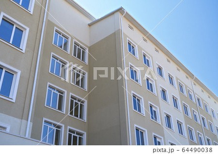 facade of a new multi-storey building with many 64490038