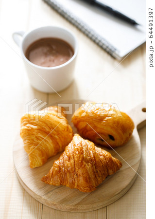 A cup of hot chocolate and croissant on wooden A cup of hot chocolate and croissant on wooden 64491397