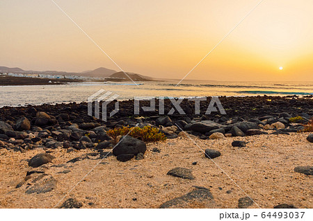 La Santa beach with ocean wave  ay sunset in Lanzarote, Canary islands 64493037