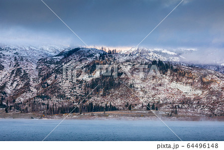 Mountain range covered by snow and cloud Mountain range covered by snow and cloud 64496148