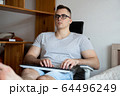 The quarantined guy works remotely from home. Communication, people and freelance work concept 64496249