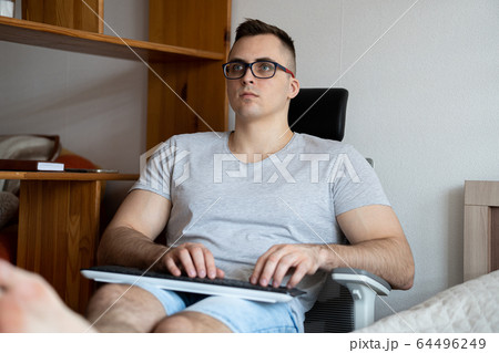 The quarantined guy works remotely from home. Communication, people and freelance work concept 64496249