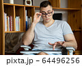 The quarantined guy works remotely from home. Communication, people and freelance work concept 64496256
