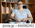 The quarantined guy works remotely from home. Communication, people and freelance work concept 64496262