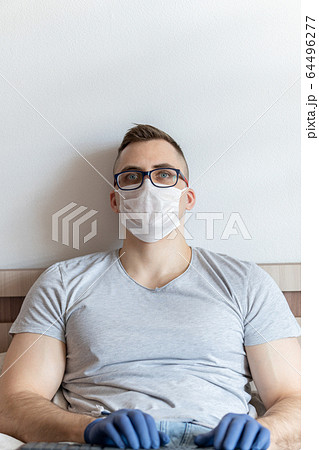The quarantined guy works remotely from the hospital. Communication, people and freelance work concept The quarantined guy works remotely from the hospital. Communication, people and freelance work concept 64496277