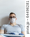 The quarantined guy works remotely from home. Communication, people and freelance work concept 64496281