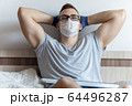 The quarantined guy works remotely from home. Communication, people and freelance work concept 64496287