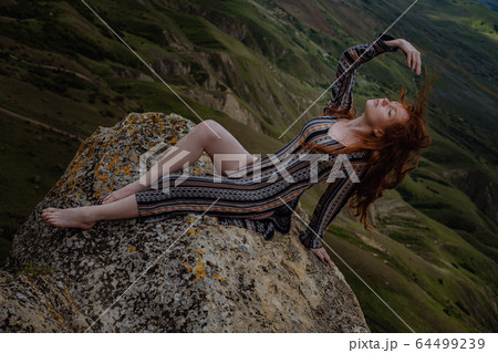 Beautiful brunette woman is enjoying spring in a 64499239