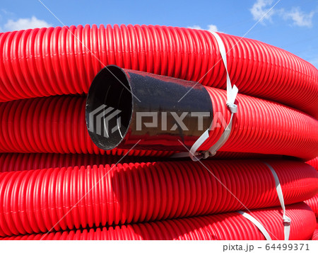 HDPE corrugated pipe with double-wall strength at the construction site. Used to protect underground cable. 64499371