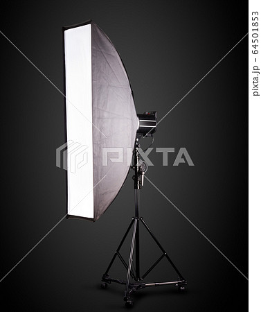 Photo studio lighting stands with flash and softbox isolated on the black. 64501853