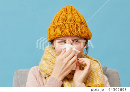 Sick woman in warm clothing Sick woman in warm clothing 64502693