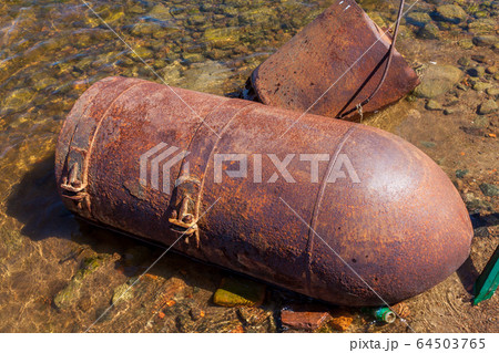 Russia. Saint-Petersburg. Metal rusty sea buoys washed up on the shore of the Gulf of Finland. 64503765