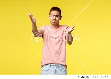 Portrait of frustrated and disappointed asian guy indicating at something distressing and bad, grimacing complaining bad work, awful quality, judging, standing skeptical yellow background Portrait of frustrated and disappointed asian guy indicating at something distressing and bad, grimacing complaining bad work, awful quality, judging, standing skeptical yellow background 64503967