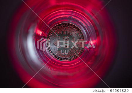 Cryptocurrency falling to the bottom. Red background and purple backlight. Cryptocurrency falling to the bottom. Red background and purple backlight. 64505329