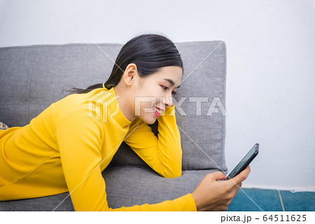 Young Asian woman watching series from online Young Asian woman watching series from online 64511625