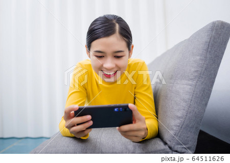 Young Asian woman watching series from online 64511626