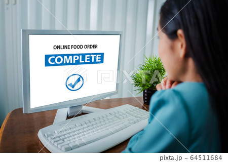 Young asian woman order food online working from 64511684