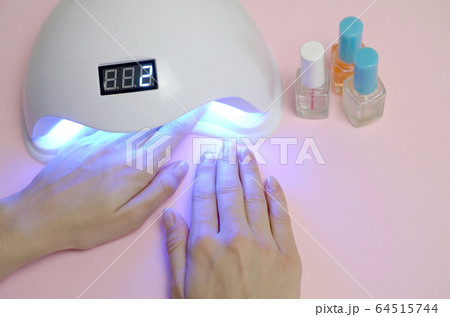 Hands of young woman at manicure procedure close Hands of young woman at manicure procedure close 64515744