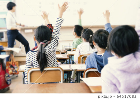 小学校の教室で手を上げる生徒達、小学生、授業 64517083