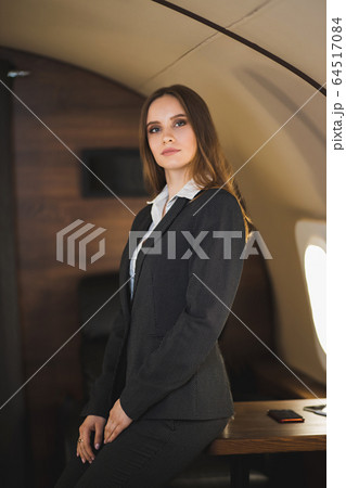Attractive woman in private jet 64517084