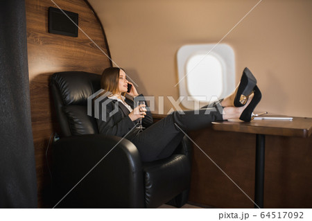 Attractive woman in private jet Attractive woman in private jet 64517092