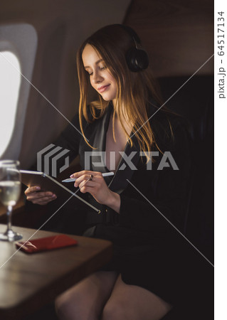 Attractive woman in private jet Attractive woman in private jet 64517134