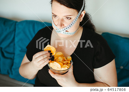 Obese woman with unhealthy food, eating disorder 64517808