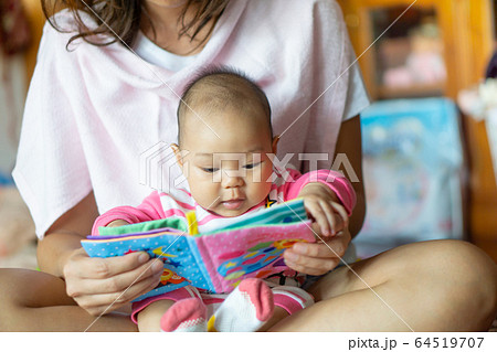 6-month-old Asian girl sat on the mother's lap and 6-month-old Asian girl sat on the mother's lap and 64519707