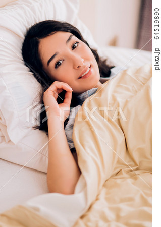 Portrait pretty young girl on bed in modern 64519890