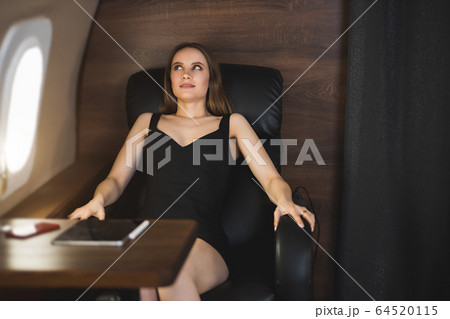 Attractive woman in private jet Attractive woman in private jet 64520115